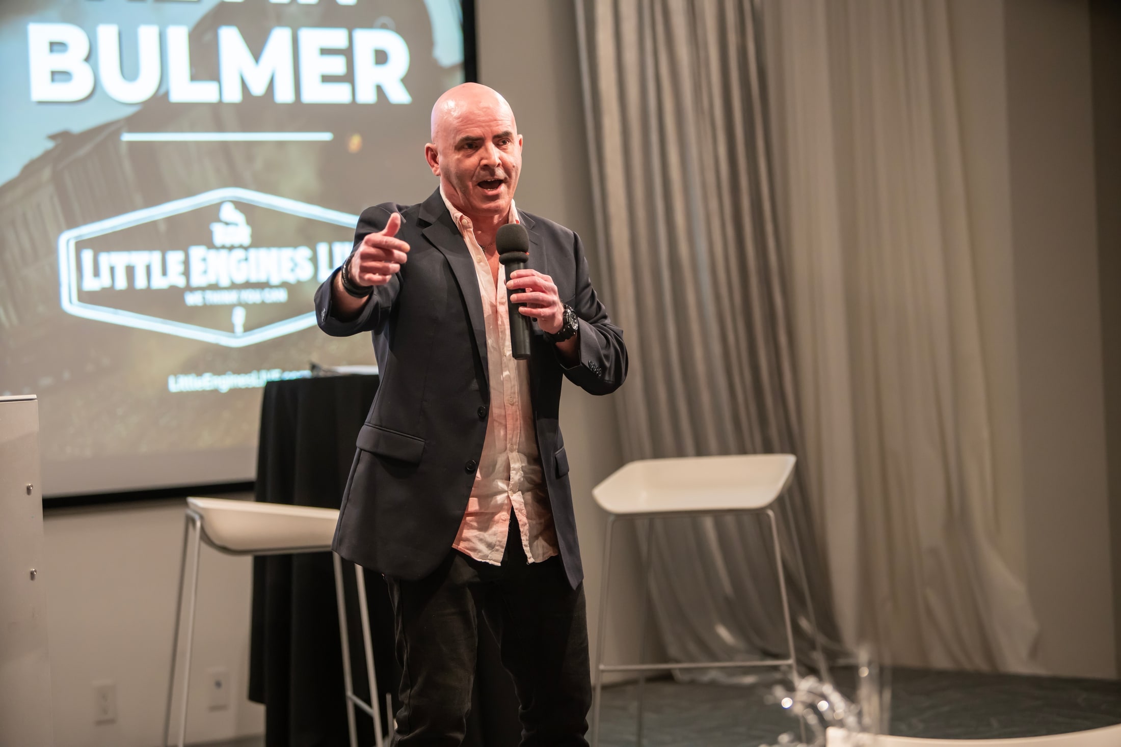Speaker presenting on stage at a conference